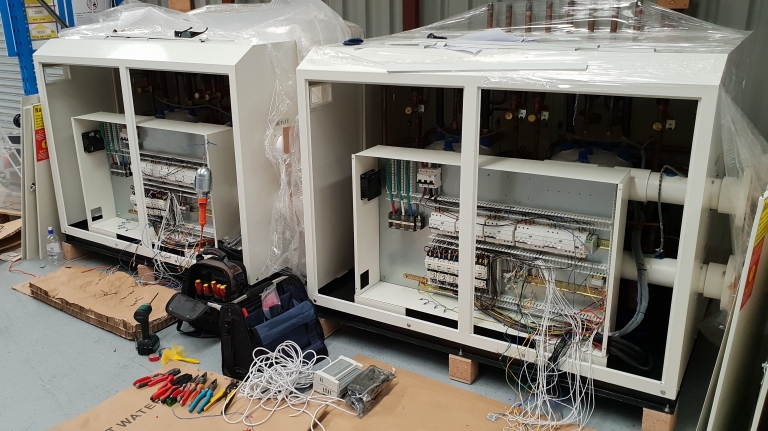 Performance Heat Pumps technicians wiring commercial heat pump units on site